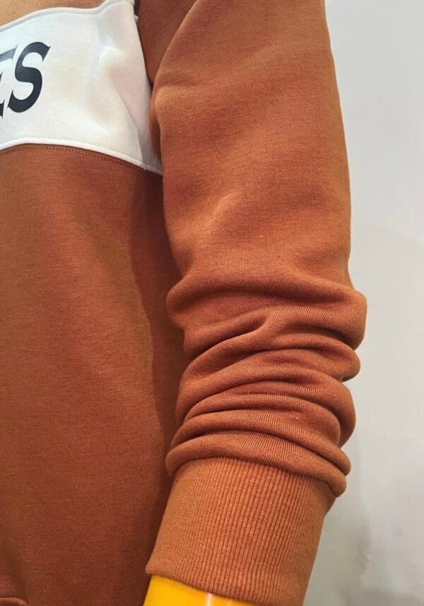 Sleeve close-up of Wearees burnt orange cotton fleece sweatshirt