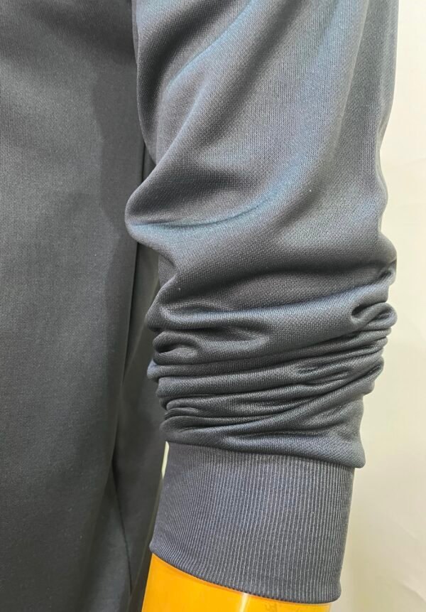 Close-up of sleeve detail on Wearees gray polyester fleece sweatshirt.